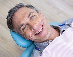 older man smiling at the dentist’s office
