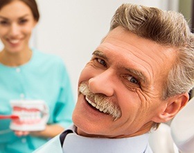 Smiling older man with dental crown and bridge restorations