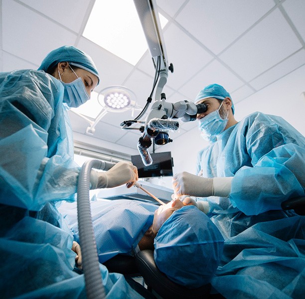 Dentists performing a dental implant surgery