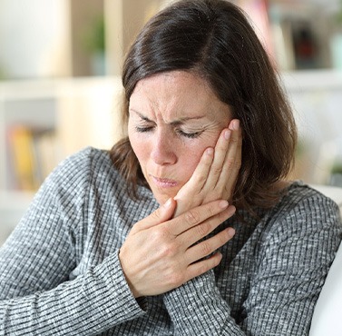 A woman experiencing oral pain