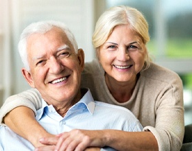 Senior couple enjoying benefits of All-on-4 dental implants