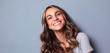 Woman showing beautiful smile after dental bonding in boca raton