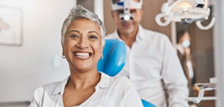 Woman smiling while sitting in dentist's treatment chair