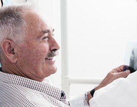 Smiling older man in dental chair for Lumineers