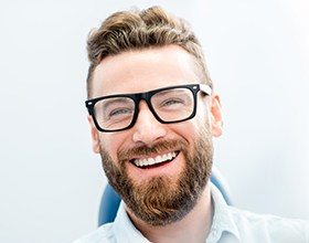 Man with bright white smile after smile perfected teeth whitening treatment