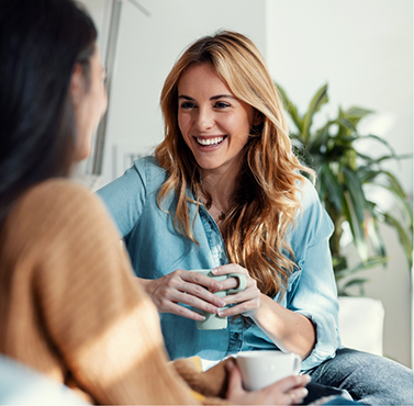 Two women chatting on a couch