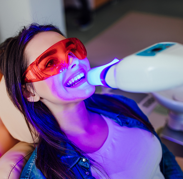 Woman getting professional teeth whitening