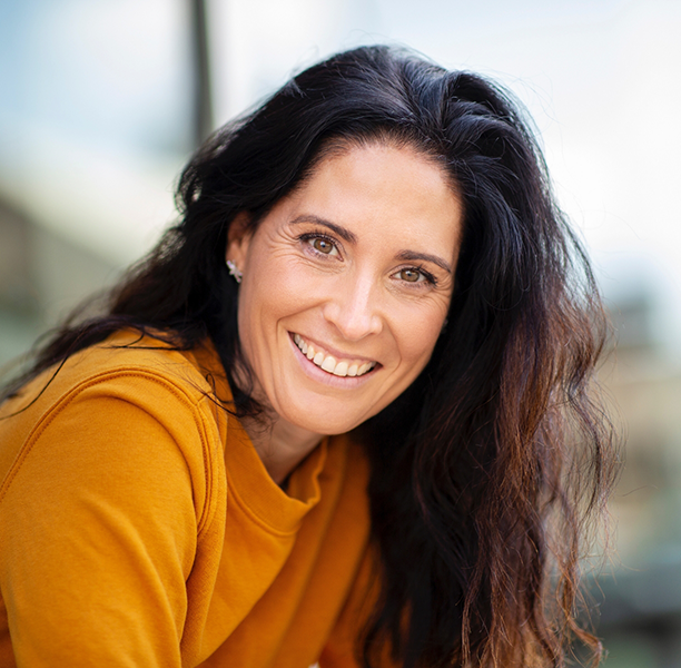 Brunette woman smiling with flawless teeth