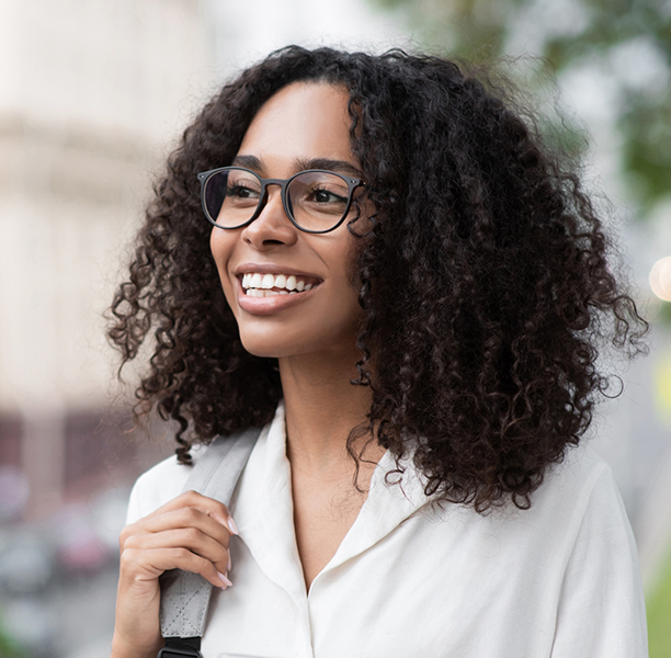 Woman in business attire smiling with flawless teeth