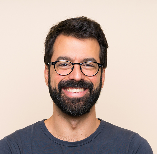 Smiling man with glasses and dark hair and beard