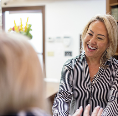 Dental team member grinning at a patient