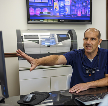 Doctor Lamberti gesturing to a computer screen