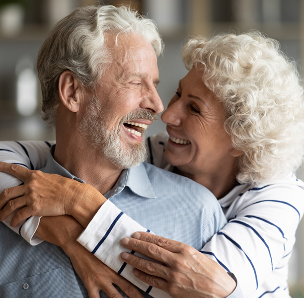 Senior couple laughing and hugging
