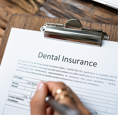 Person filling out dental insurance paperwork