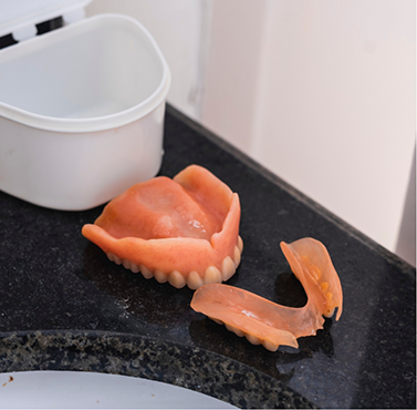 Dentures sitting on a bathroom counter