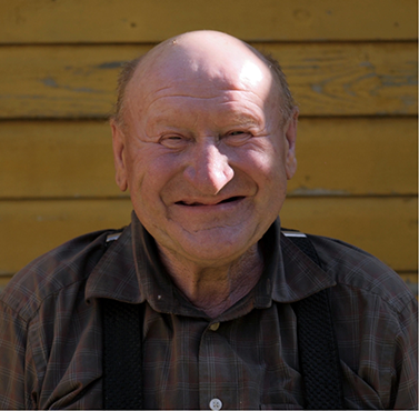 Smiling older man missing all of his teeth