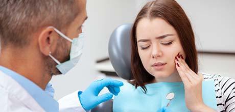 Pained woman visiting her Boca Raton emergency dentist