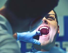 Dentist examining patient for a dental emergency in Boca Raton