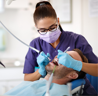 Dental hygienist cleaning a patient's teeth