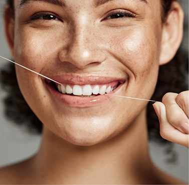 Woman flossing her teeth