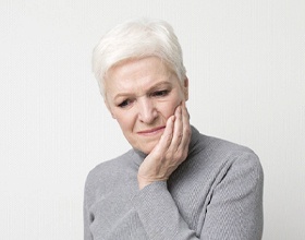 Older woman worried about dental implant failure in Boca Raton