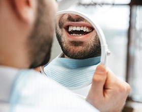 A man admiring his tooth-colored fillings in Boca Raton