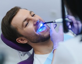 Dentist preparing to apply fluoride to patient’s teeth
