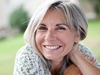 older woman smiling in nature