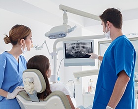 dentist showing a patient their dental X-rays