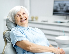 Smiling senior woman showing her dental implant restorations