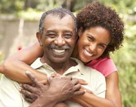 Man and adult daughter with beautiful implant restorations