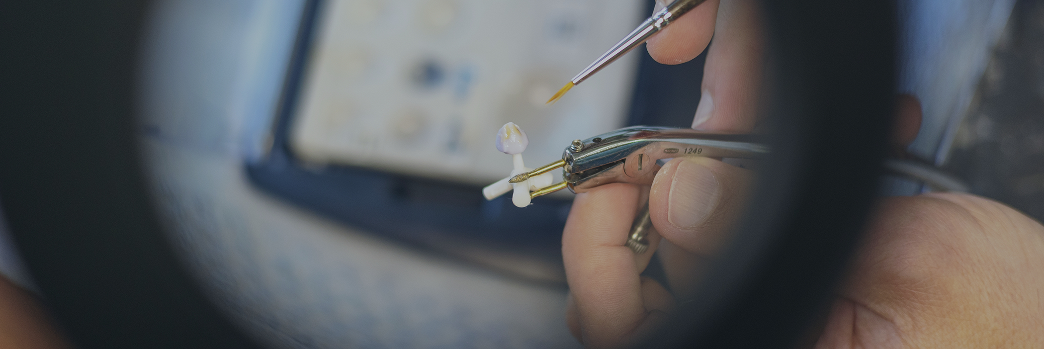 Dental professional carefully crafting a dental crown