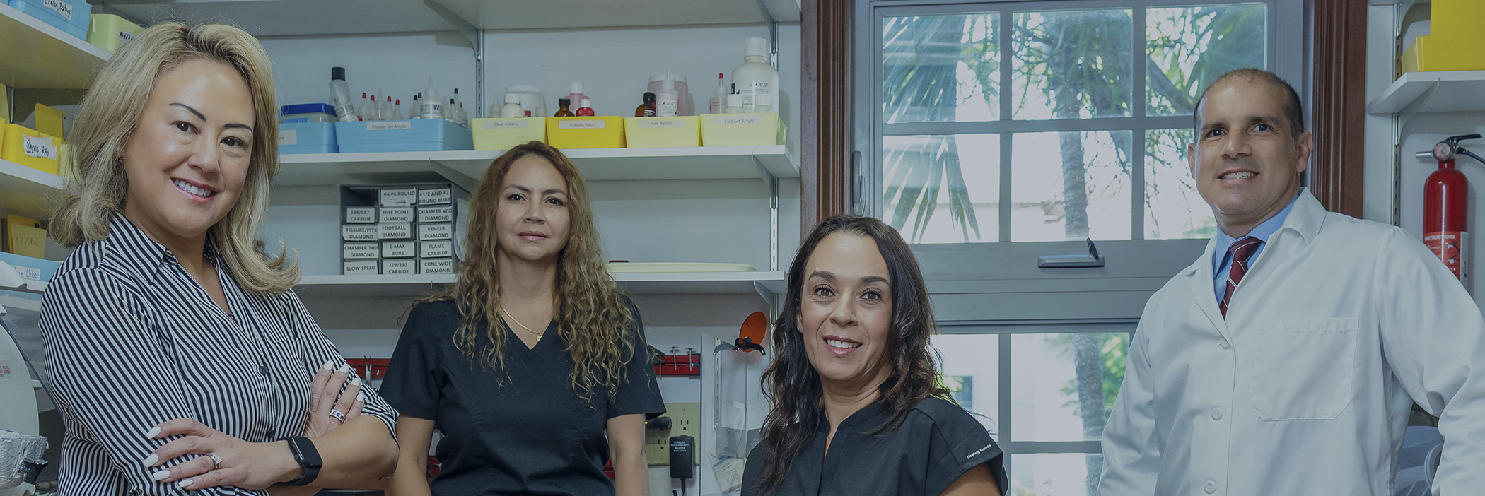 Four smiling dental team members at Alberto J. Lamberti, DMD