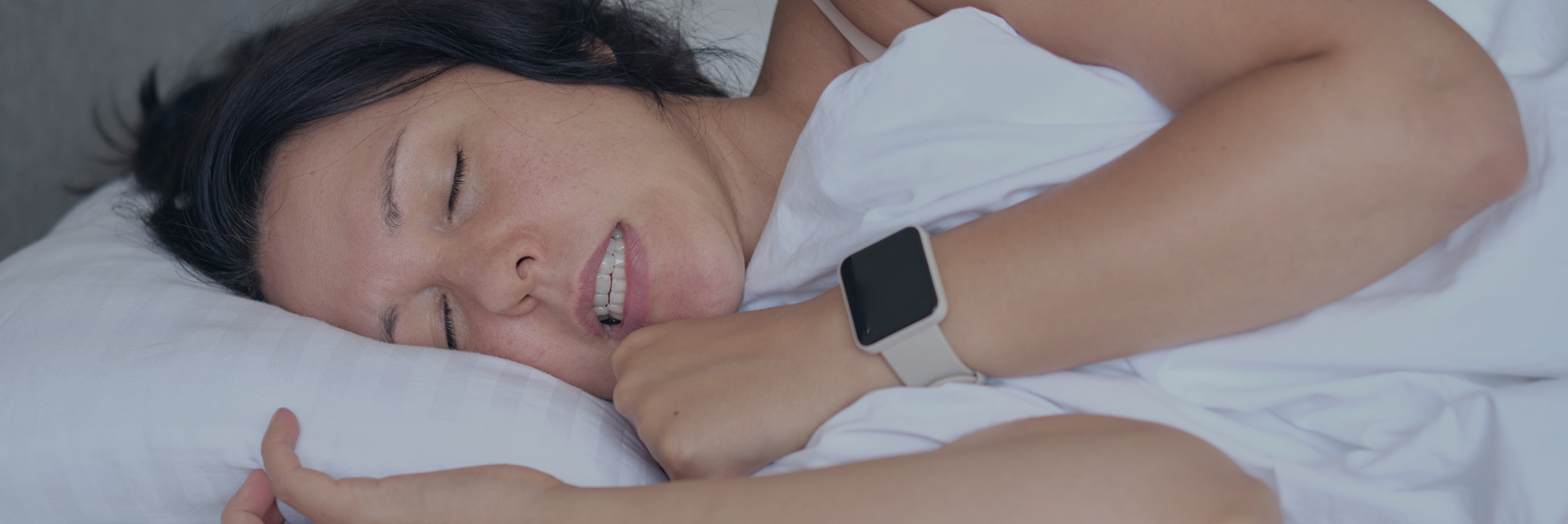 Sleeping woman clenching and grinding her teeth