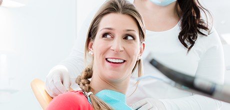 Woman in dental chair smiling during preventive dentistry visit