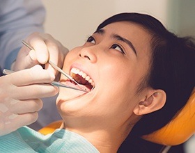 Woman receiving gum disease exam