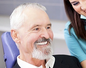Smiling older man with dental implant supported replacement teeth
