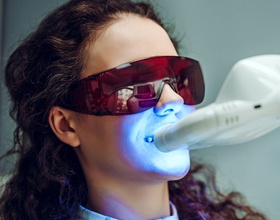 Woman receiving in office smile perfected teeth whitening procedure