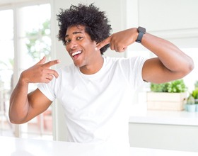 Man showing off bright smile after smile perfected teeth whitening