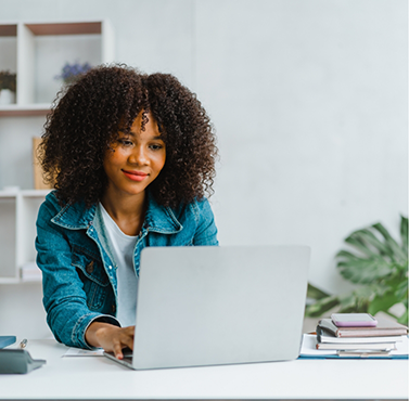 Woman looking at a laptop at a desk