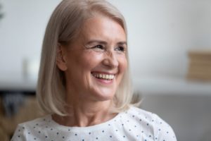 happy, smiling older woman in white shirt with healthy smile