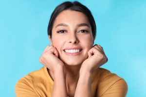 Young woman with beautiful smile after visiting cosmetic dentist Boca Raton