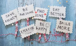 Resolutions written on decorative paper on a wooden background